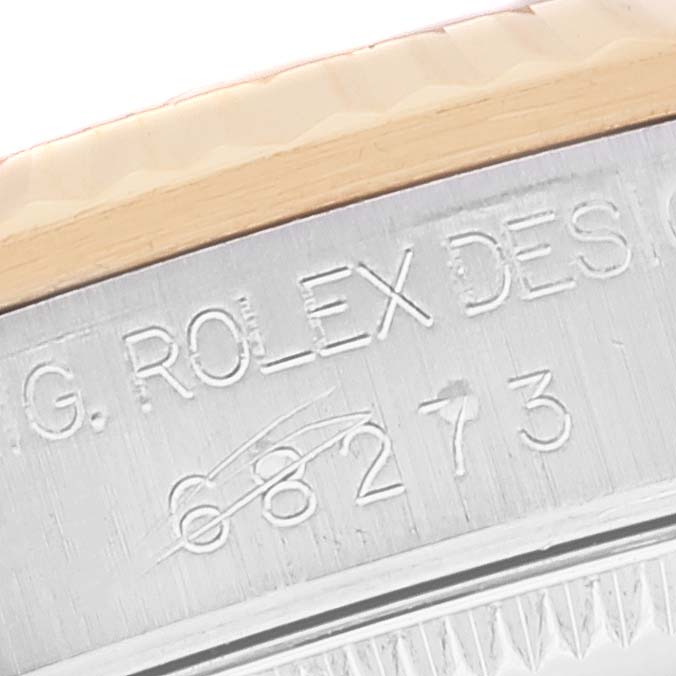 This image shows a close-up of the engraved serial number on the case back of a Mid-Size Rolex watch.