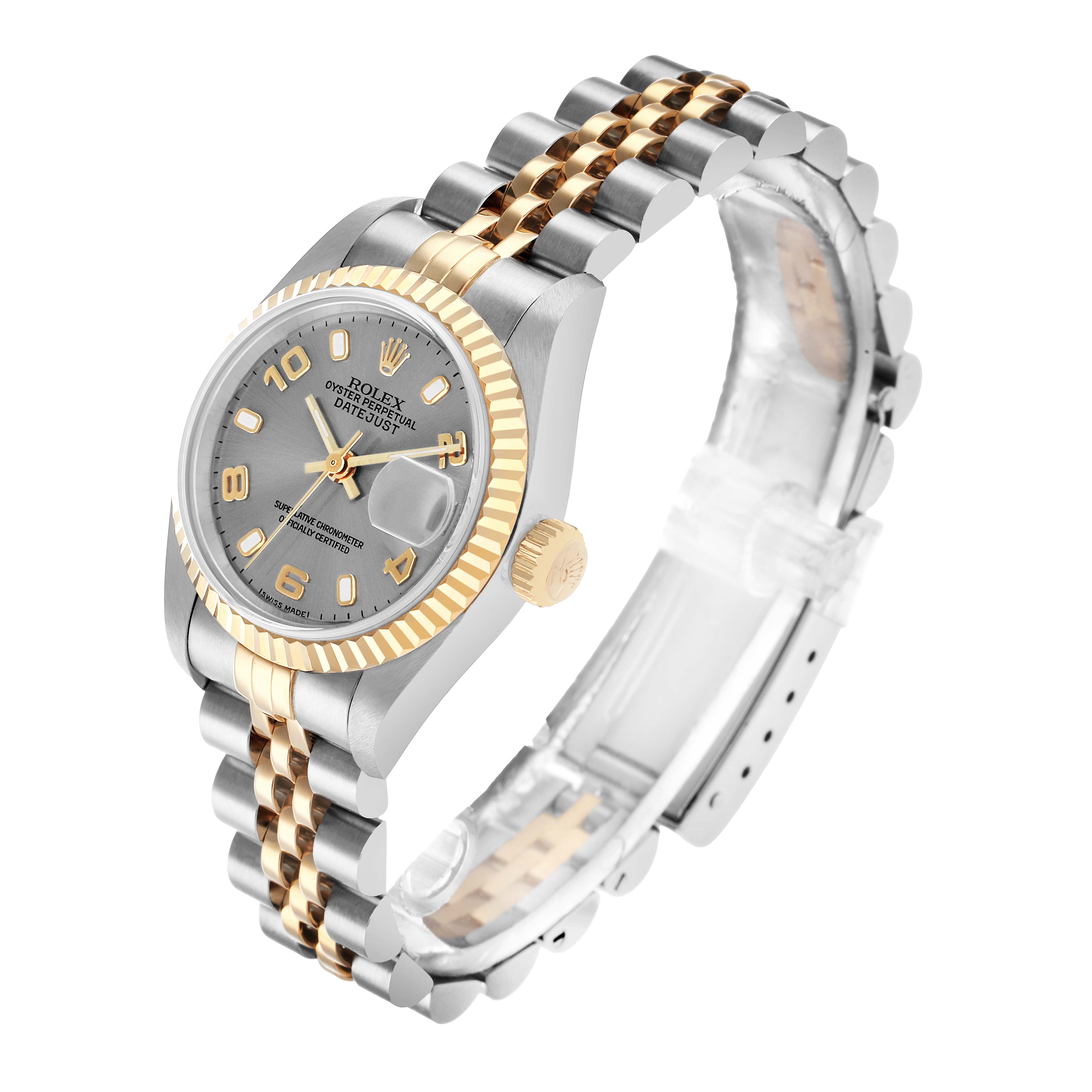 The Rolex Datejust 79173 Women
s Steel and Gold (two tone) Silver Dial watch is shown at an angle displaying the face, fluted bezel, crown, and two-tone Jubilee bracelet.