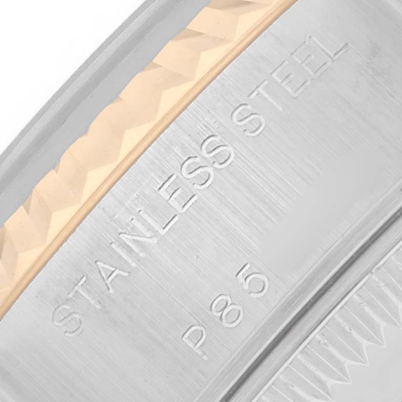 The image shows a close-up of the side of a Rolex Datejust 79173 Women
s Steel and Gold (two tone) Silver Dial watch, highlighting the stainless steel and gold fluted bezel.