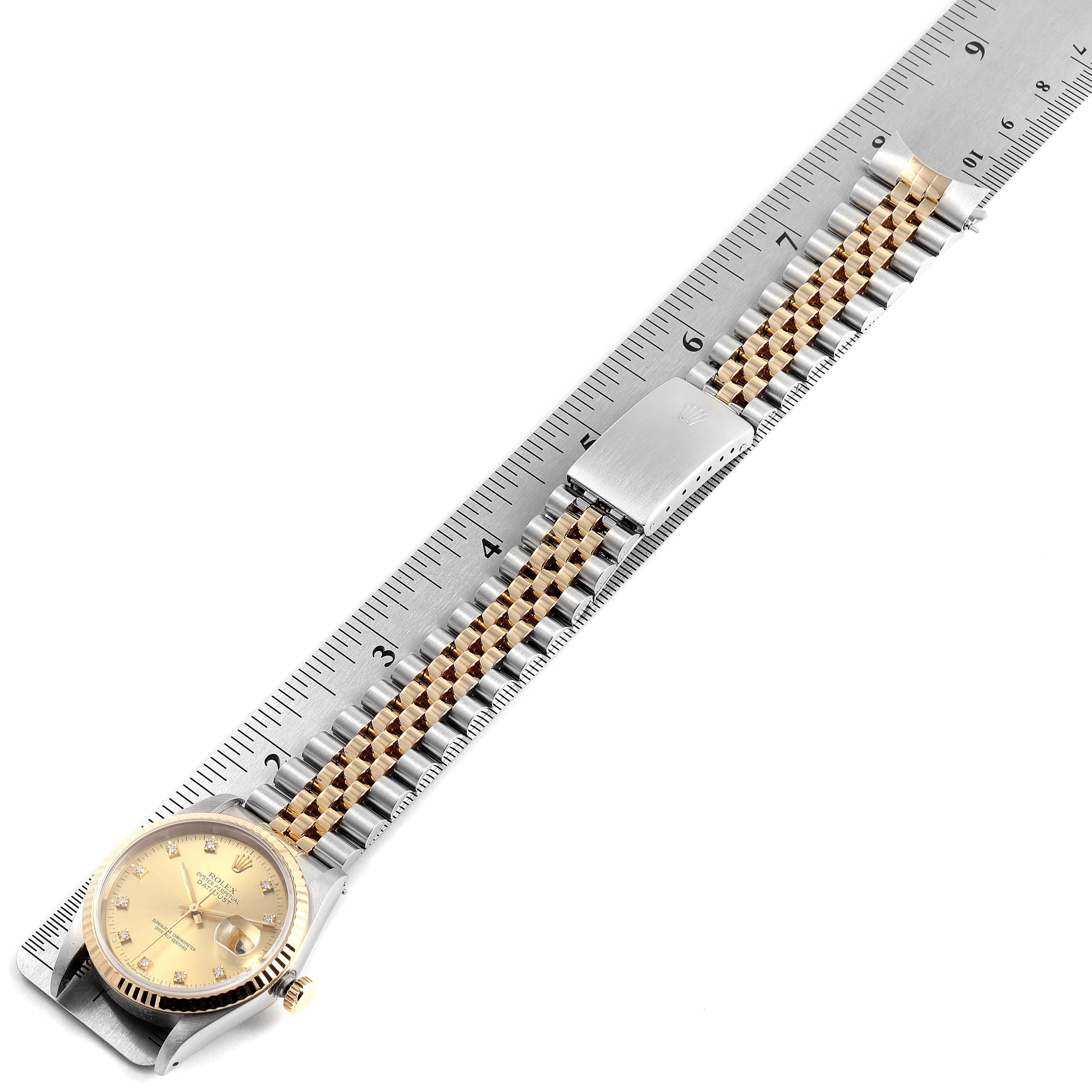 The Rolex Datejust 16233 Men
s Steel and Gold (two tone) Champagne Dial 16233 Men
s Steel and Gold (two tone) Champagne Dial watch is shown from a top-down angle, highlighting the face, band, and deployment clasp.