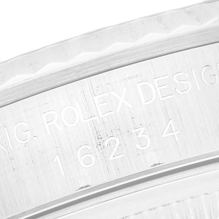 The image shows an engraved side profile of a Rolex Datejust 16234 Men's Stainless Steel Silver Dial 16234 Men's Stainless Steel Silver Dial watch, displaying part of the bezel and the text "ROLEX DESIGN."