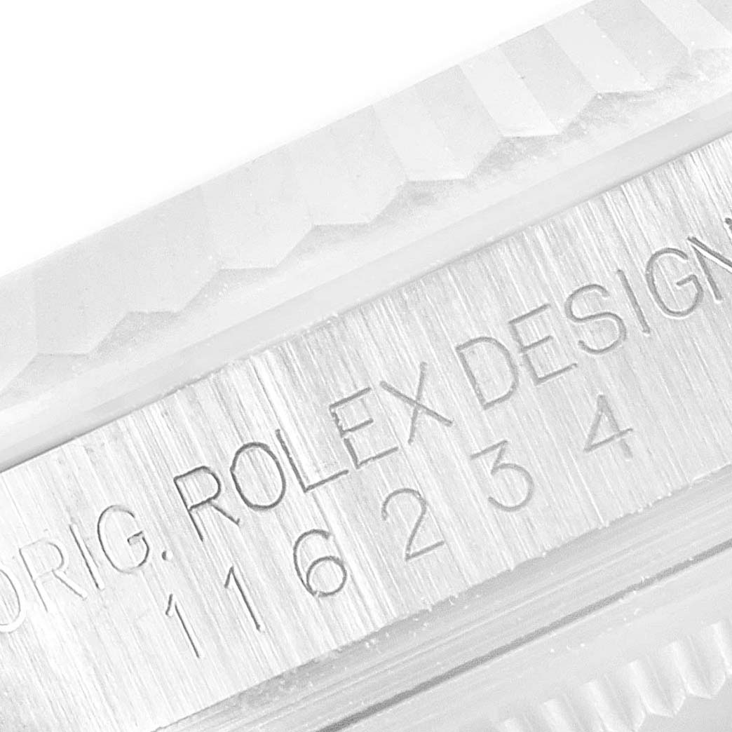 This image shows a close-up of the side engraving and part of the fluted bezel of a Rolex Datejust 116234 Men's Stainless Steel Silver Dial 116234 Men's Stainless Steel Silver Dial watch.