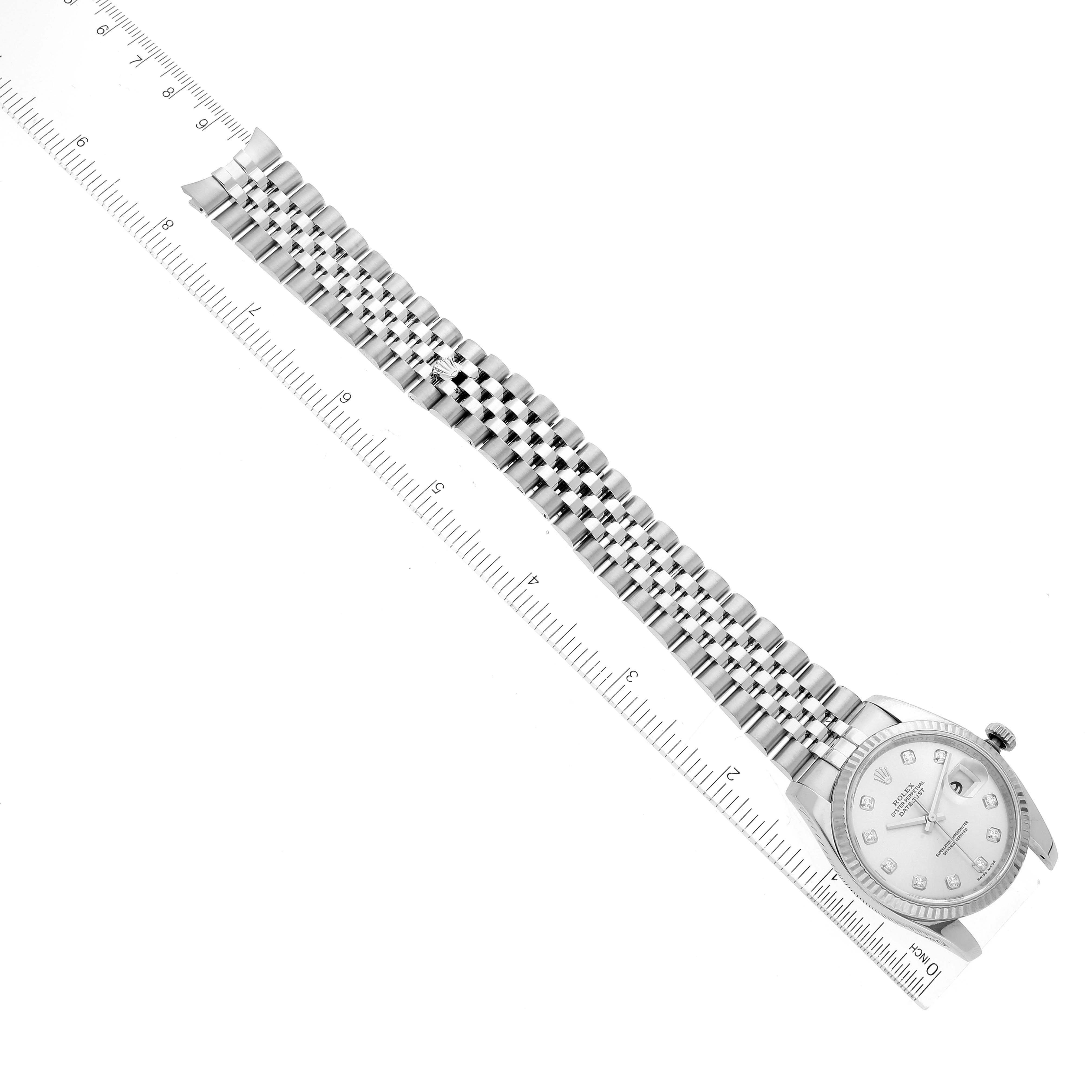 This image shows a Rolex Datejust 116234 Men's Stainless Steel Silver Dial 116234 Men's Stainless Steel Silver Dial watch laid flat, highlighting the face and full length of the metal bracelet next to a ruler.