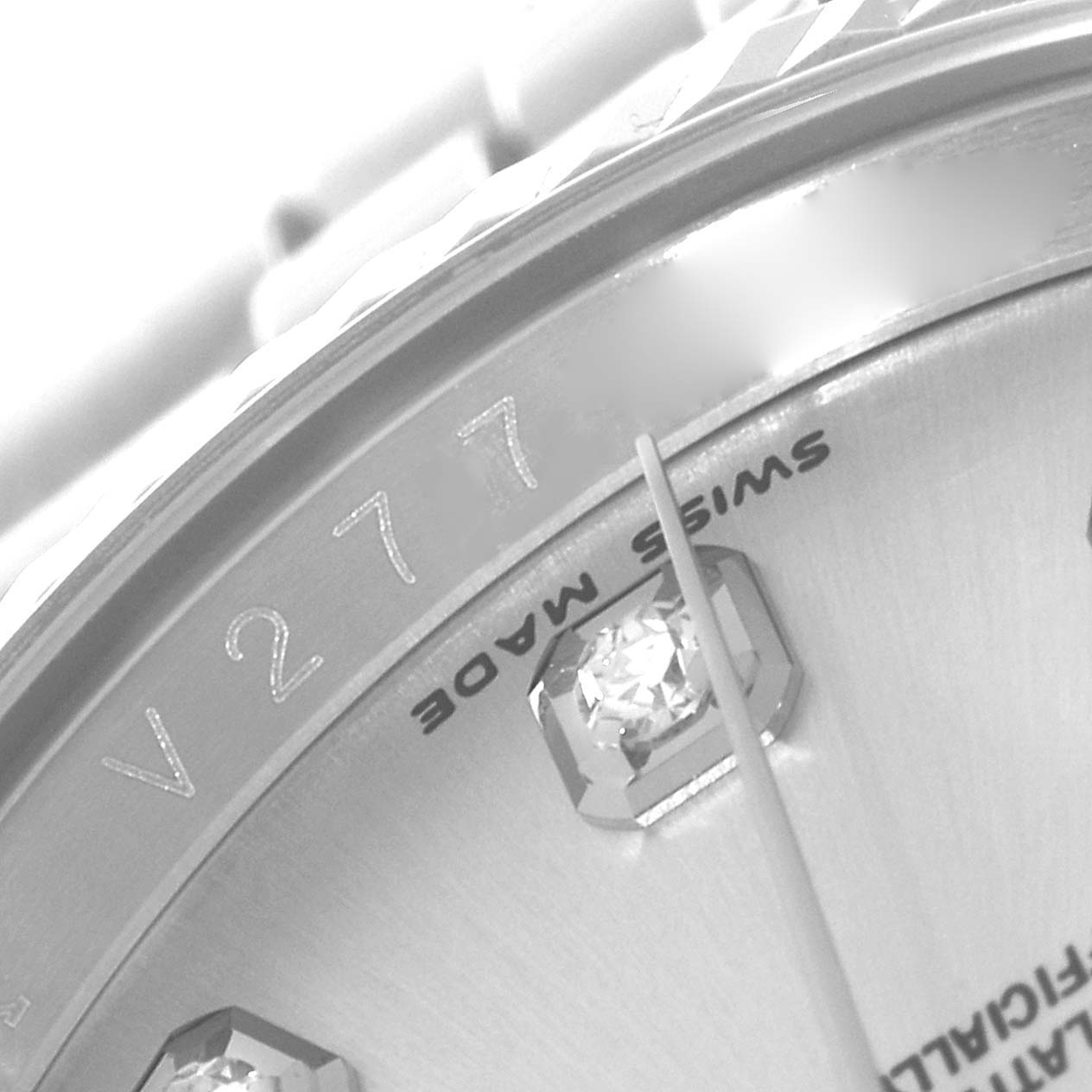This close-up shows a portion of the dial, including diamond hour markers and part of the "Swiss Made" label, of a Rolex Datejust 116234 Men's Stainless Steel Silver Dial 116234 Men's Stainless Steel Silver Dial model.