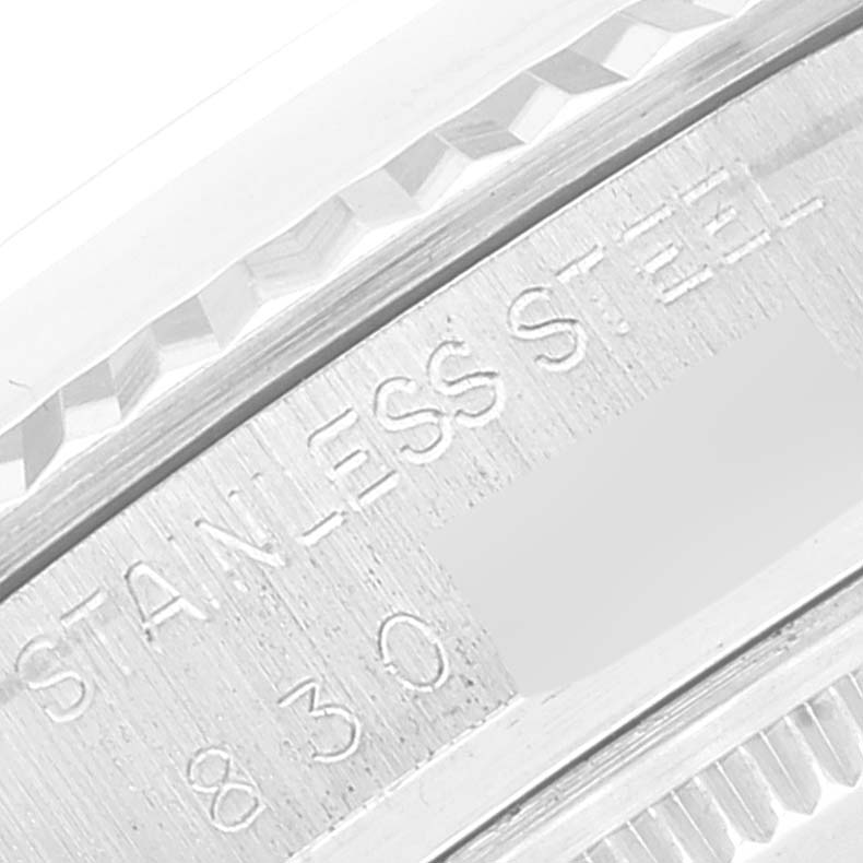 This close-up shows part of the casing and the engraving on the Vintage Collection Rolex watch, indicating "STAINLESS STEEL."