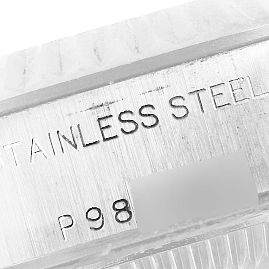 This image shows a close-up of the engraved serial number and "STAINLESS STEEL" text on a Rolex Datejust 79174 Women
s Stainless Steel White Dial 79174 Women
s Stainless Steel White Dial watch case.