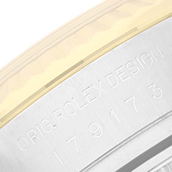 The image shows an angled close-up of the case back and edge of the bezel of a Rolex Datejust 179173 Women's Steel and Gold (two tone) Black Dial 179173 Women's Steel and Gold (two tone) Black Dial watch.