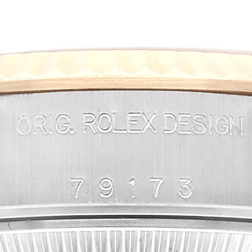 This image shows a close-up of the case side of a Rolex Datejust 79173 Women's Steel and Gold (two tone) Black Dial 79173 Women's Steel and Gold (two tone) Black Dial watch, displaying the engravings "ORIG. ROLEX DESIGN" and the model number "79173."