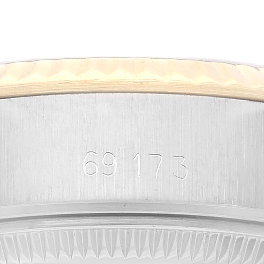 This close-up image shows the engraved casing and bezel of a Rolex Datejust 69173 Women's Steel and Gold (two tone) Champagne Dial 69173 Women's Steel and Gold (two tone) Champagne Dial watch from a side angle.