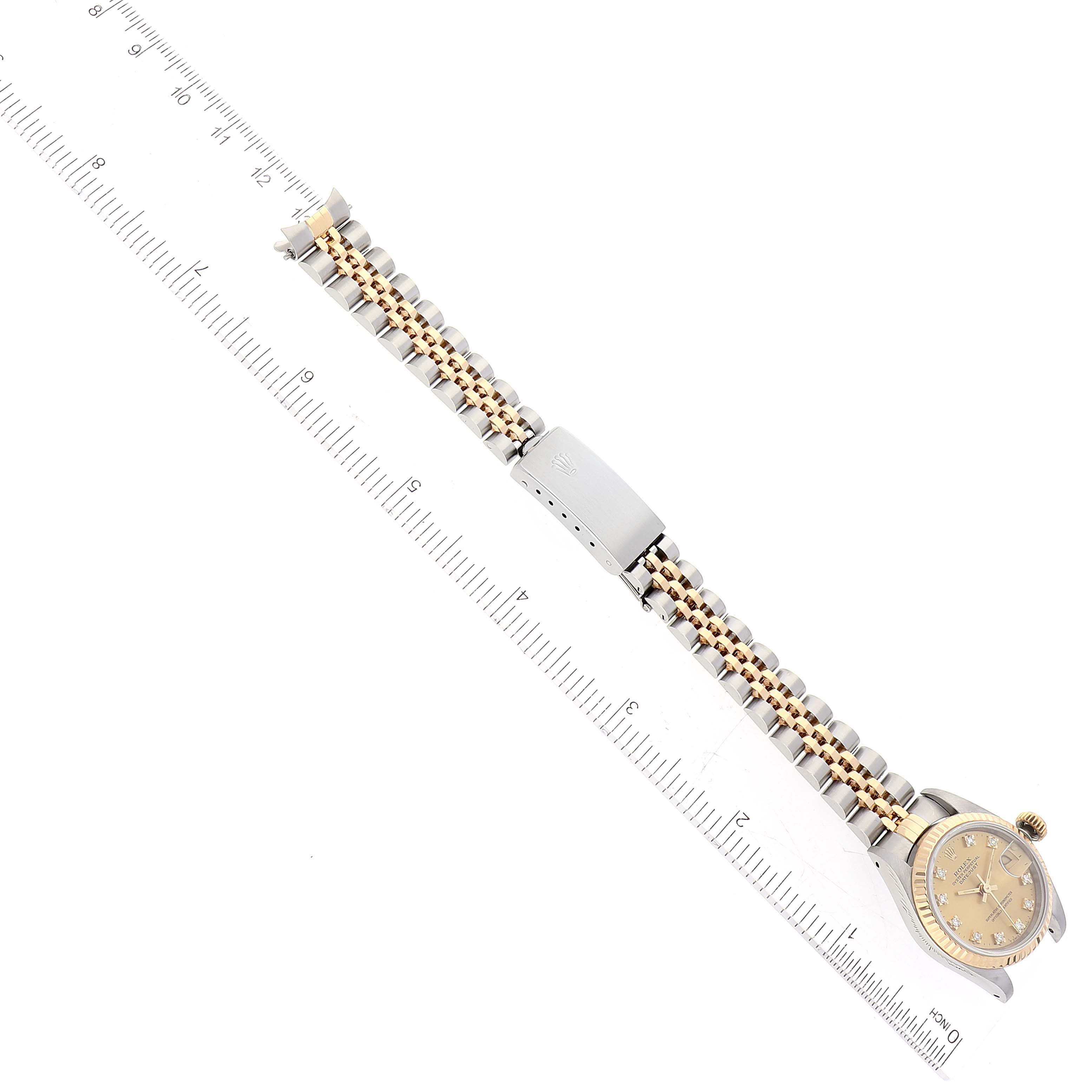 The image shows a Rolex Datejust 69173 Women's Steel and Gold (two tone) Champagne Dial 69173 Women's Steel and Gold (two tone) Champagne Dial watch laid flat, including the dial and entire wristband, alongside a ruler for scale.