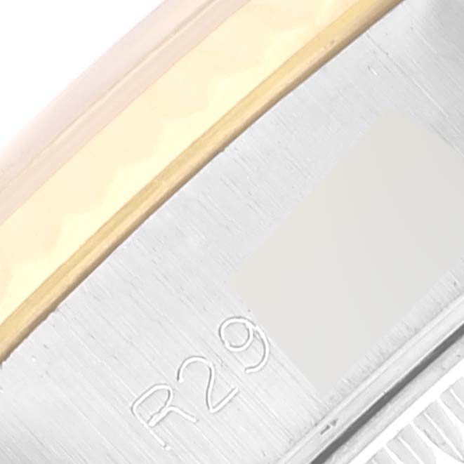 The image shows a close-up of the edge of the bezel with engravings and part of the band, specifically from a Rolex Datejust 69173 Women's Steel and Gold (two tone) Champagne Dial 69173 Women's Steel and Gold (two tone) Champagne Dial model.