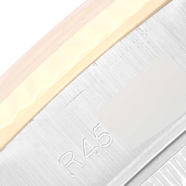 This close-up image shows the brushed metal edge and engraved markings ("R45") on the bezel of a Rolex Datejust 69173 Women's Steel and Gold (two tone) Champagne Dial 69173 Women's Steel and Gold (two tone) Champagne Dial watch.