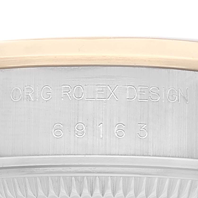 The image shows the side of a Rolex Datejust 69163 Women's Steel and Gold (two tone) Champagne Dial 69163 Women's Steel and Gold (two tone) Champagne Dial watch case, focusing on the engraving "ORIG ROLEX DESIGN" and model number "69163."