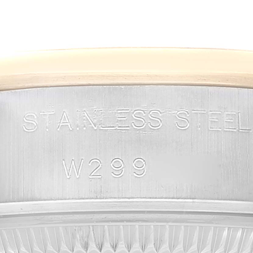 This image shows a close-up of the side of a Rolex Datejust 69163 Women's Steel and Gold (two tone) Champagne Dial 69163 Women's Steel and Gold (two tone) Champagne Dial watch case, highlighting the stainless steel material and the model number W299.