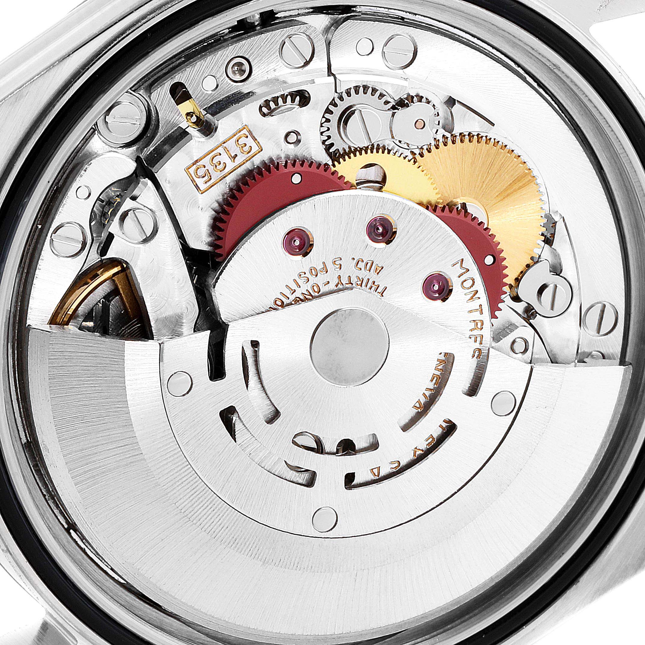The image shows the inner mechanism of a Rolex Datejust 16233 Men's Steel and Gold (two tone) Silver Dial 16233 Men's Steel and Gold (two tone) Silver Dial watch, focusing on its intricate gears and movement parts.