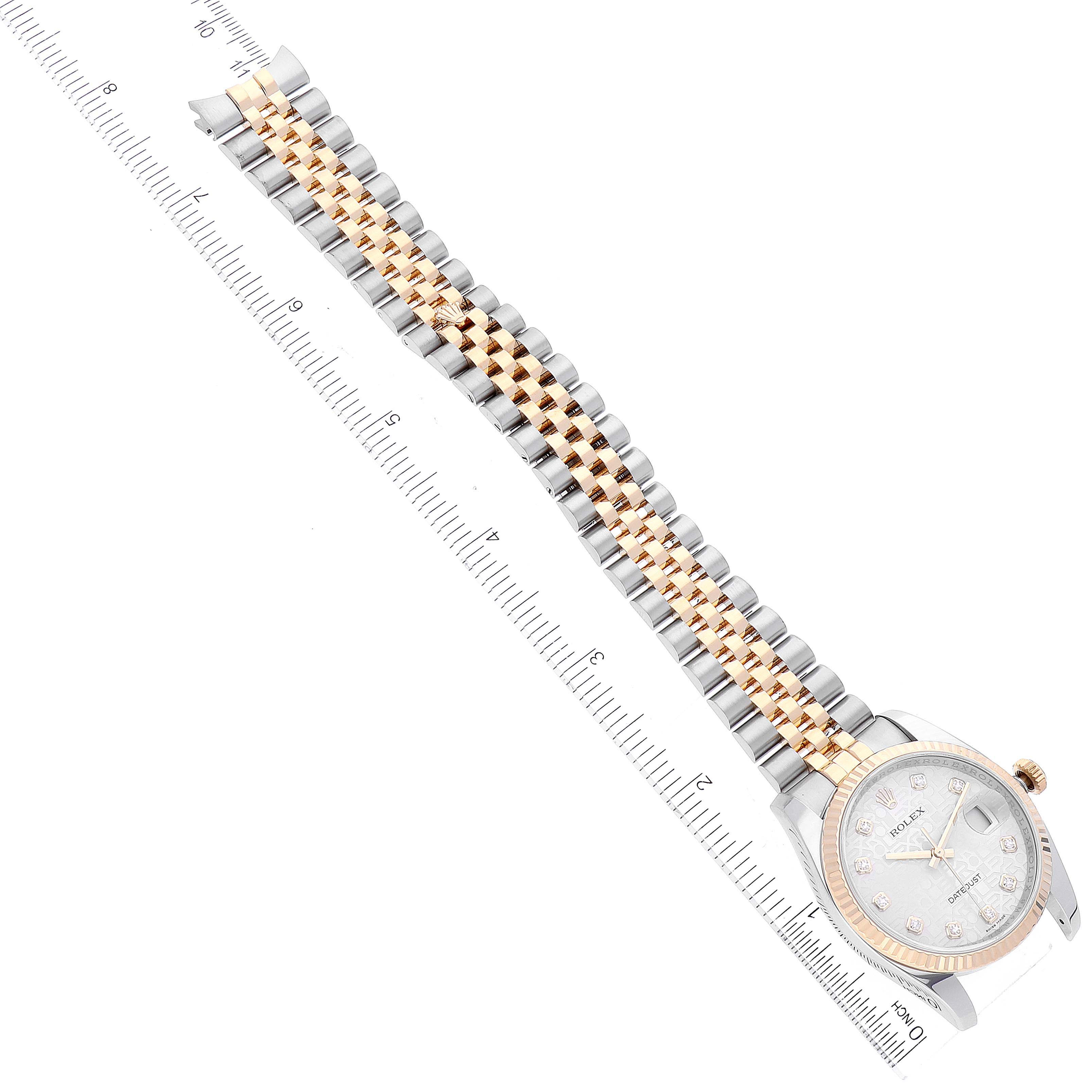 The Rolex Datejust 116233 Men's Steel and Gold (two tone) Silver Dial 116233 Men's Steel and Gold (two tone) Silver Dial watch is shown from an overhead angle, displaying the face, bezel, and full bracelet alongside a ruler.