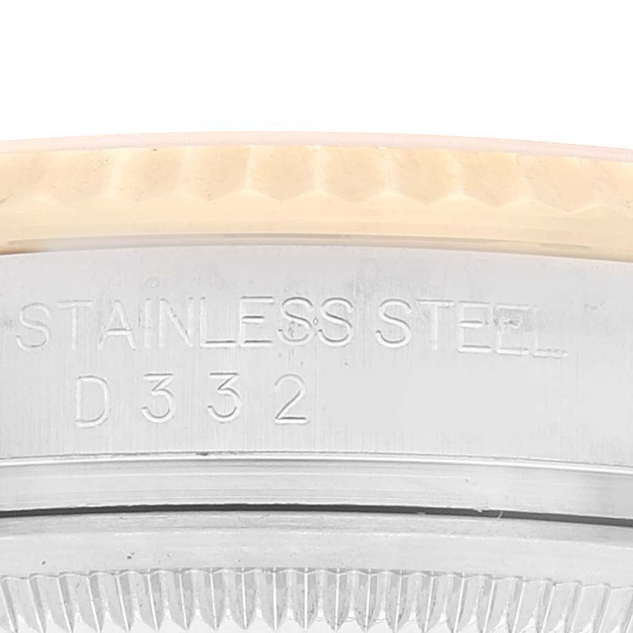 This image shows a close-up of the edge of a stainless steel Rolex Datejust 116233 Men's Steel and Gold (two tone) Silver Dial 116233 Men's Steel and Gold (two tone) Silver Dial watch case, featuring the engraved serial number.