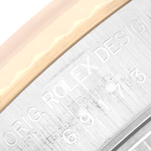 This close-up image shows the engraved side of the Rolex Datejust 69173 Women's Steel and Gold (two tone) Champagne Dial 69173 Women's Steel and Gold (two tone) Champagne Dial watch case with part of the bezel.
