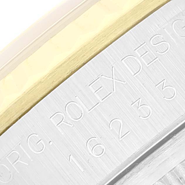 This is a close-up of the side of the watch case showing the engraved text on a Rolex Datejust 16233 Men's Steel and Gold (two tone) White Dial 16233 Men's Steel and Gold (two tone) White Dial model.