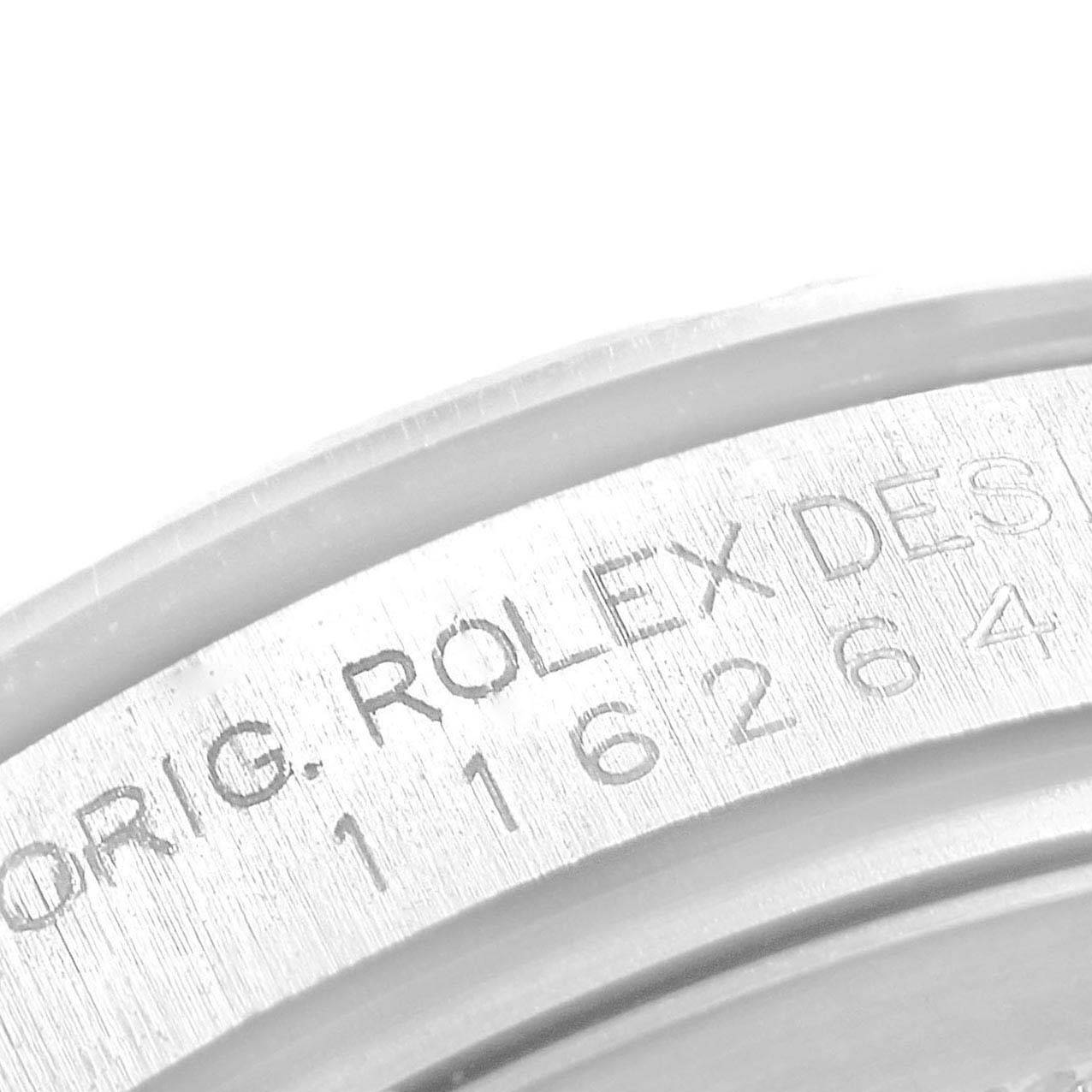 This image shows a close-up of the engraved serial number on the case of a Rolex Turn-o-Graph 116264 Men
s Stainless Steel Blue Dial 116264 Men
s Stainless Steel Blue Dial watch.