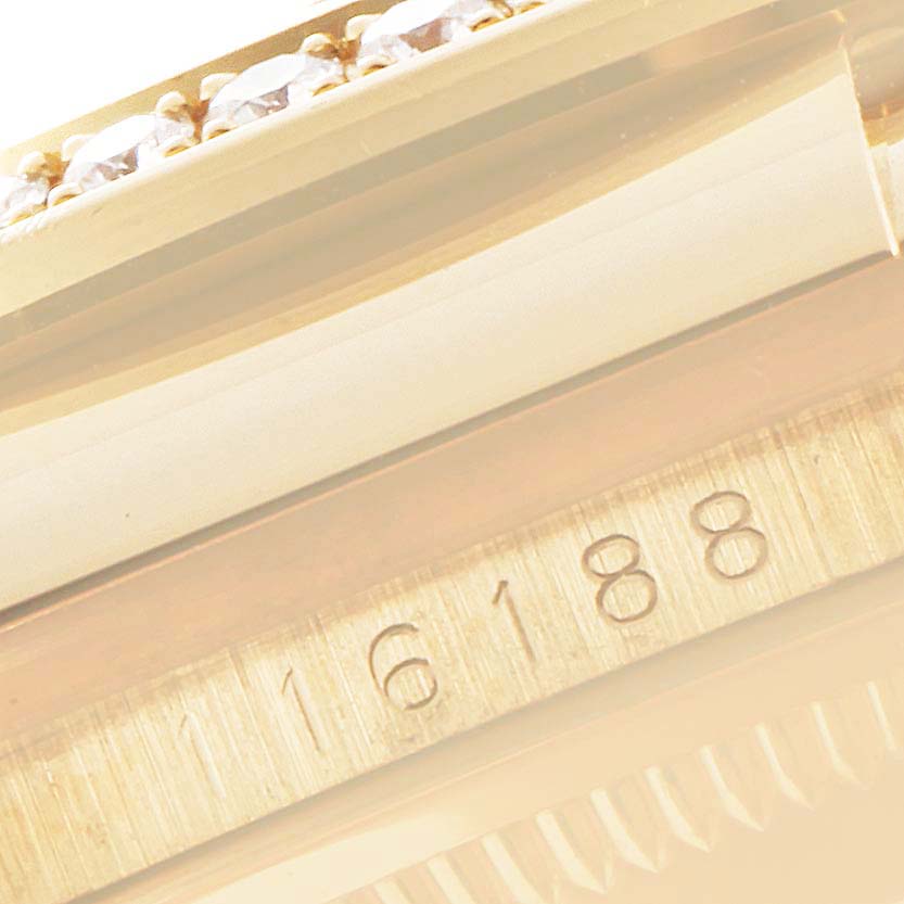 The image shows a close-up of the side of a Rolex Datejust 116188 Men's Yellow Gold Mother of Pearl Dial 116188 Men's Yellow Gold Mother of Pearl Dial watch, focusing on the bezel and serial number.