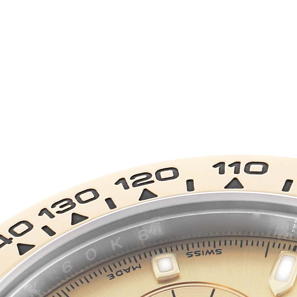 The image shows a close-up of the bezel and part of the dial of a Rolex Daytona 116503 Men
s Steel and Gold (two tone) Champagne Dial, with markings for measuring speed.