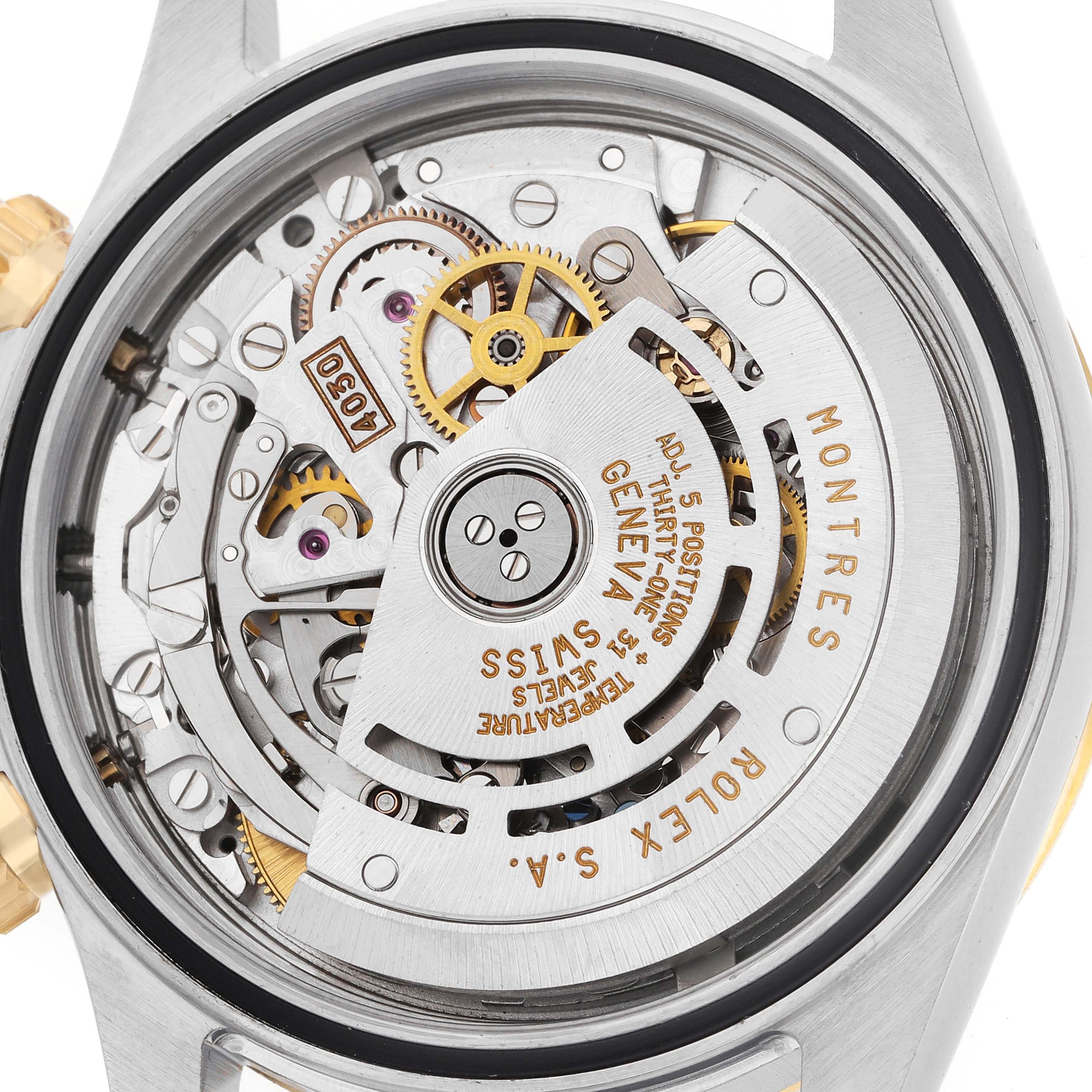 The image shows the movement from the back of a Rolex Daytona 16523 Men
s Steel and Gold (two tone) Black Dial, highlighting gears and inscriptions.