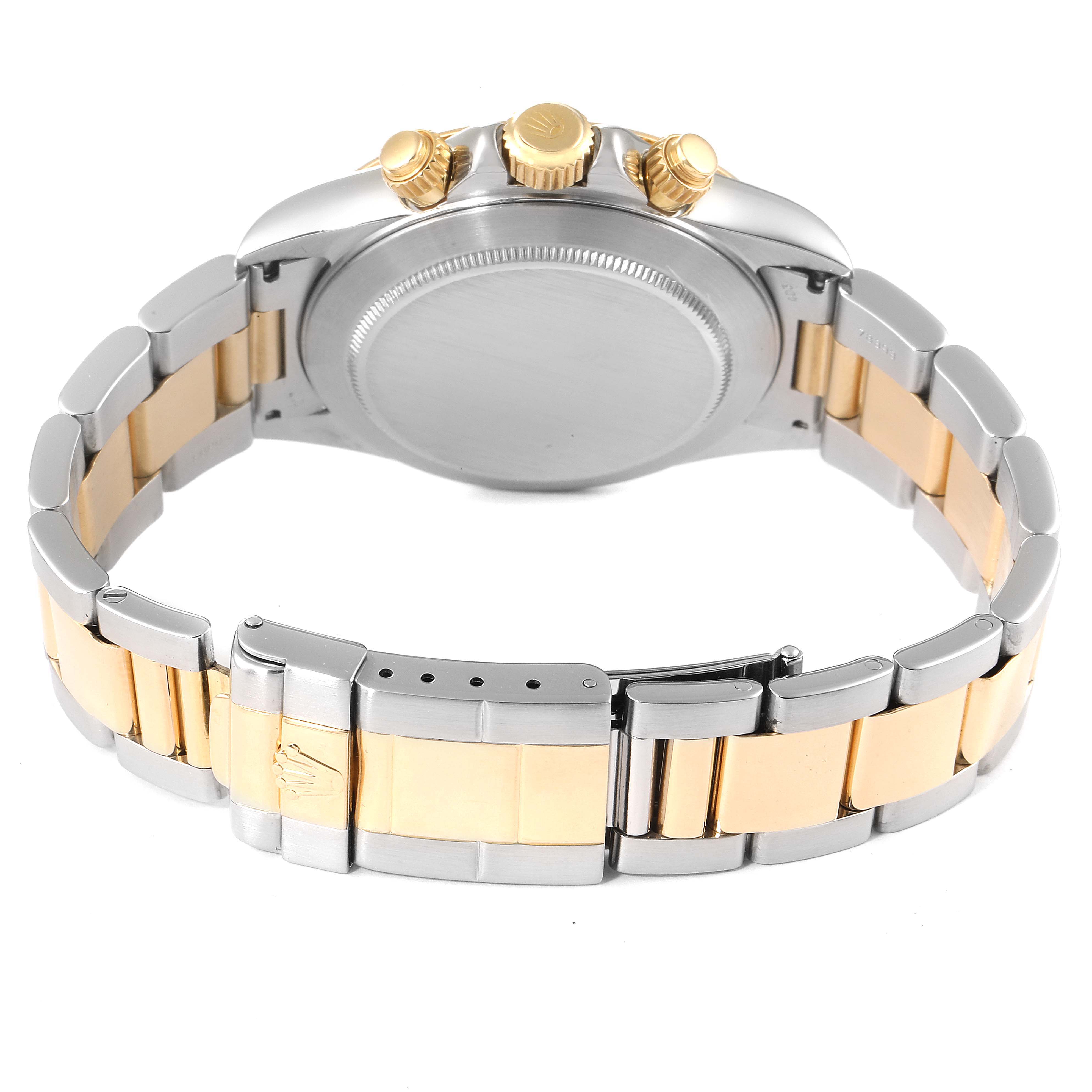 The image shows the back of a Rolex Daytona 16523 Men
s Steel and Gold (two tone) Champagne Dial 16523 Men
s Steel and Gold (two tone) Champagne Dial watch, highlighting the bracelet and clasp with gold accents.