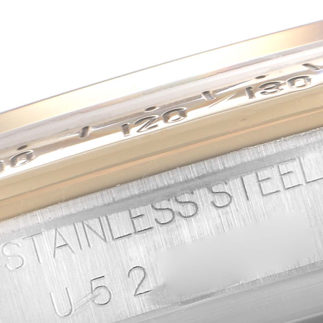 This image shows a close-up of the bezel and engraved stainless steel case of a Rolex Daytona 16523 Men
s Steel and Gold (two tone) Champagne Dial 16523 Men
s Steel and Gold (two tone) Champagne Dial watch.