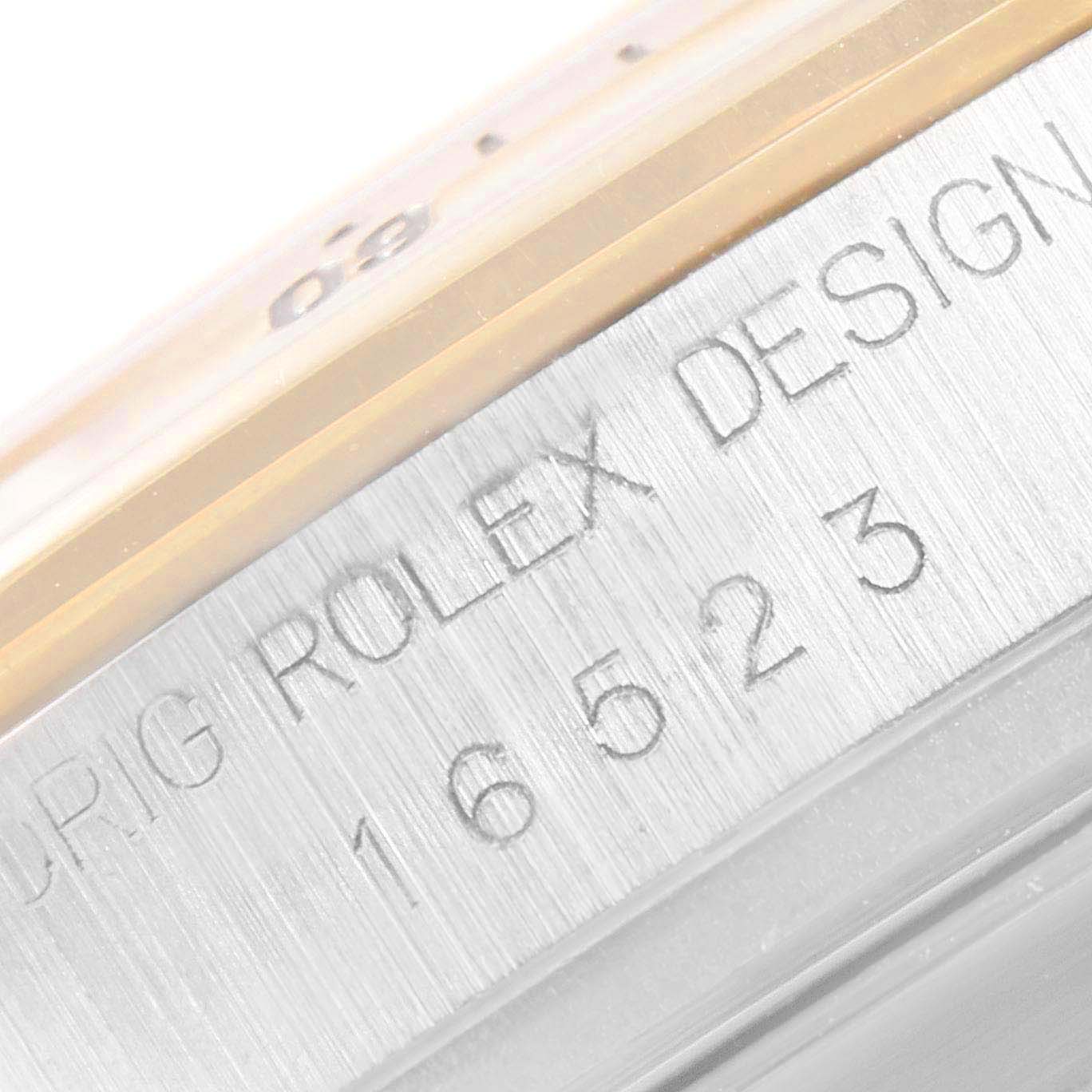 This close-up image shows the engraved model number and part of the bezel of the Rolex Daytona 16523 Men
s Steel and Gold (two tone) Champagne Dial 16523 Men
s Steel and Gold (two tone) Champagne Dial watch.