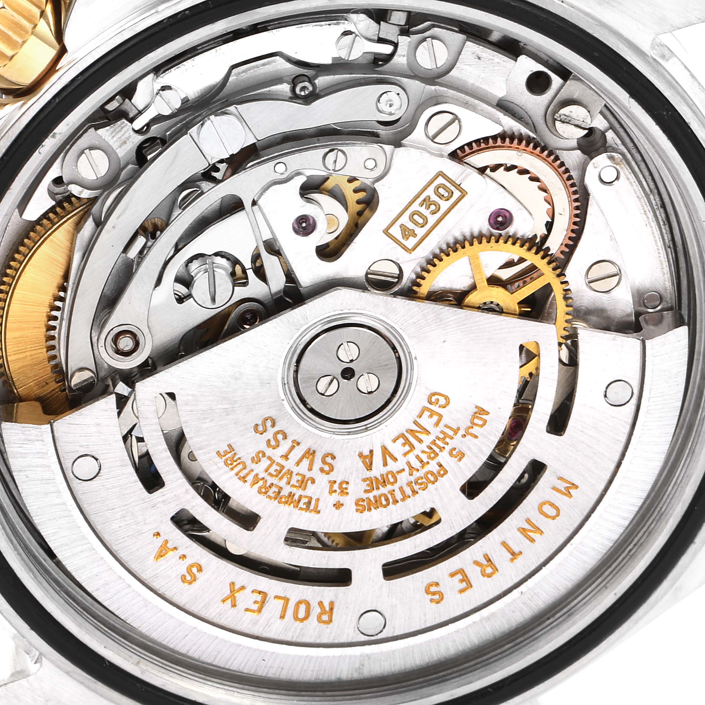 This is an angled close-up of the internal mechanics and movement of a Rolex Daytona 16523 Men
s Steel and Gold (two tone) Champagne Dial 16523 Men
s Steel and Gold (two tone) Champagne Dial watch, displaying gears and inscriptions.