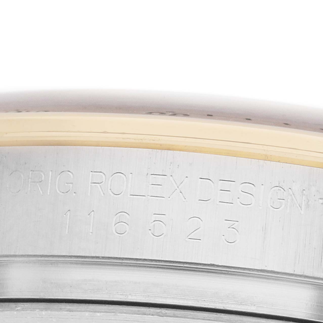 The image shows the side of a Rolex Daytona 116523 Men
s Steel and Gold (two tone) Silver Dial watch with the model number engraved on the metal surface.