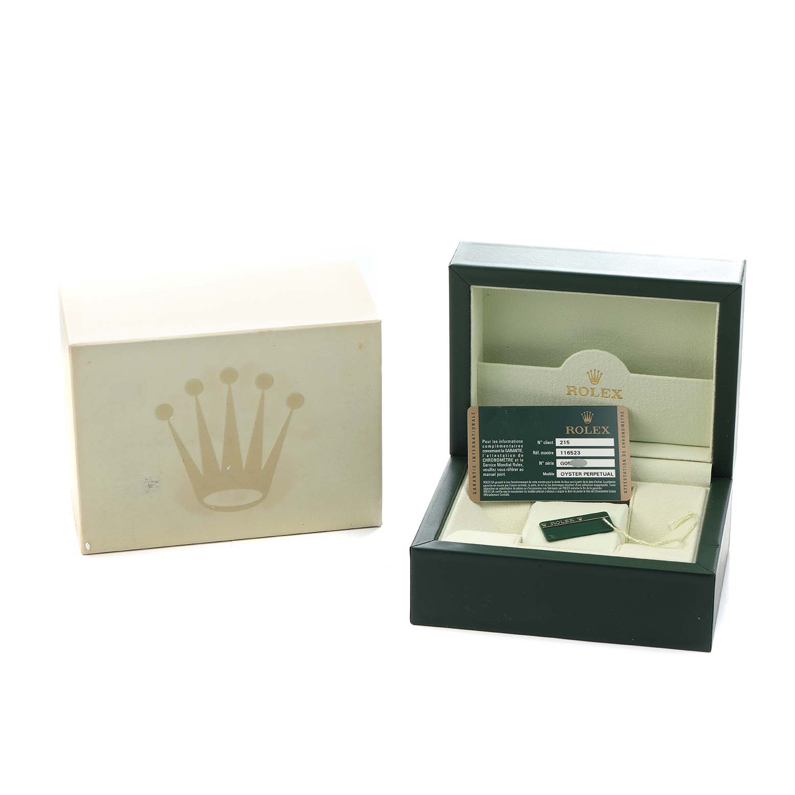 The image shows the packaging and accessories of a Rolex Daytona 116523 Men
s Steel and Gold (two tone) Silver Dial, including a box, card, and tag, viewed from above.