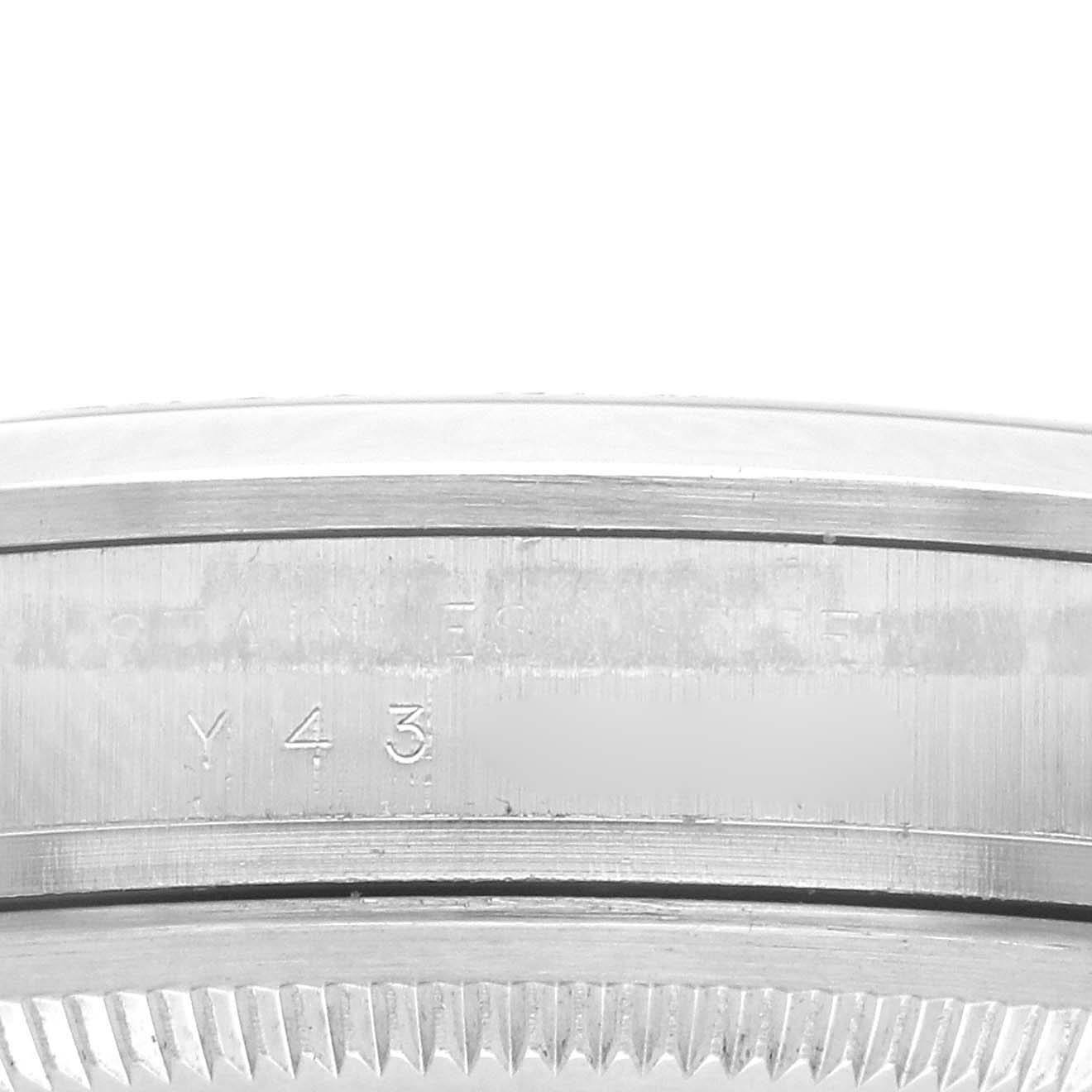 The image shows a close-up of the side case of a Rolex Explorer 114270 Men
s Stainless Steel Black Dial watch, highlighting the bezel and serial engraving.