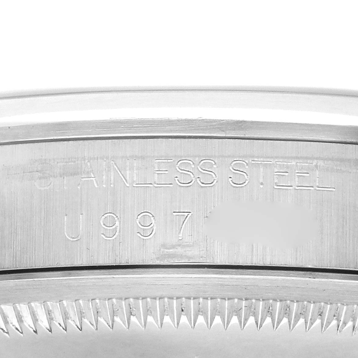 The image shows a close-up of the case side of a Rolex Explorer 14270 Men
s Stainless Steel Black Dial, highlighting the stainless steel material and engravings.