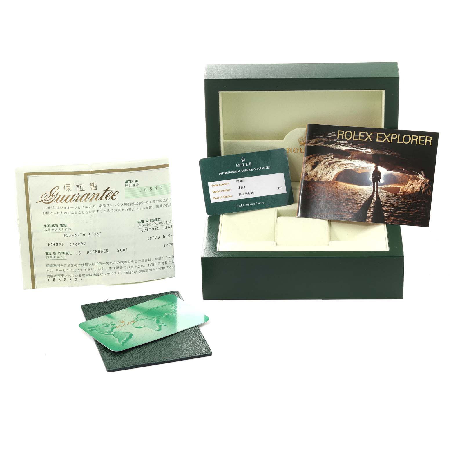 The image shows a Rolex Explorer 16570 Men
s Stainless Steel Black Dial 16570 Men
s Stainless Steel Black Dial watch box, guarantee documents, service card, and a booklet, viewed from the front.