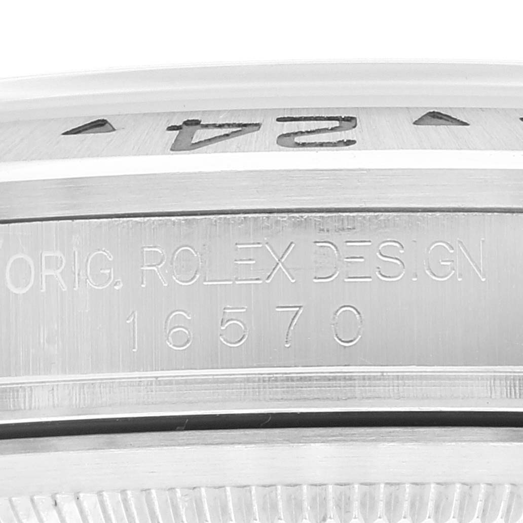 The image shows a close-up of the engraving on the side of a Rolex Explorer 16570 Men
s Stainless Steel Black Dial 16570 Men
s Stainless Steel Black Dial model 16570, highlighting the bezel and part of the case.