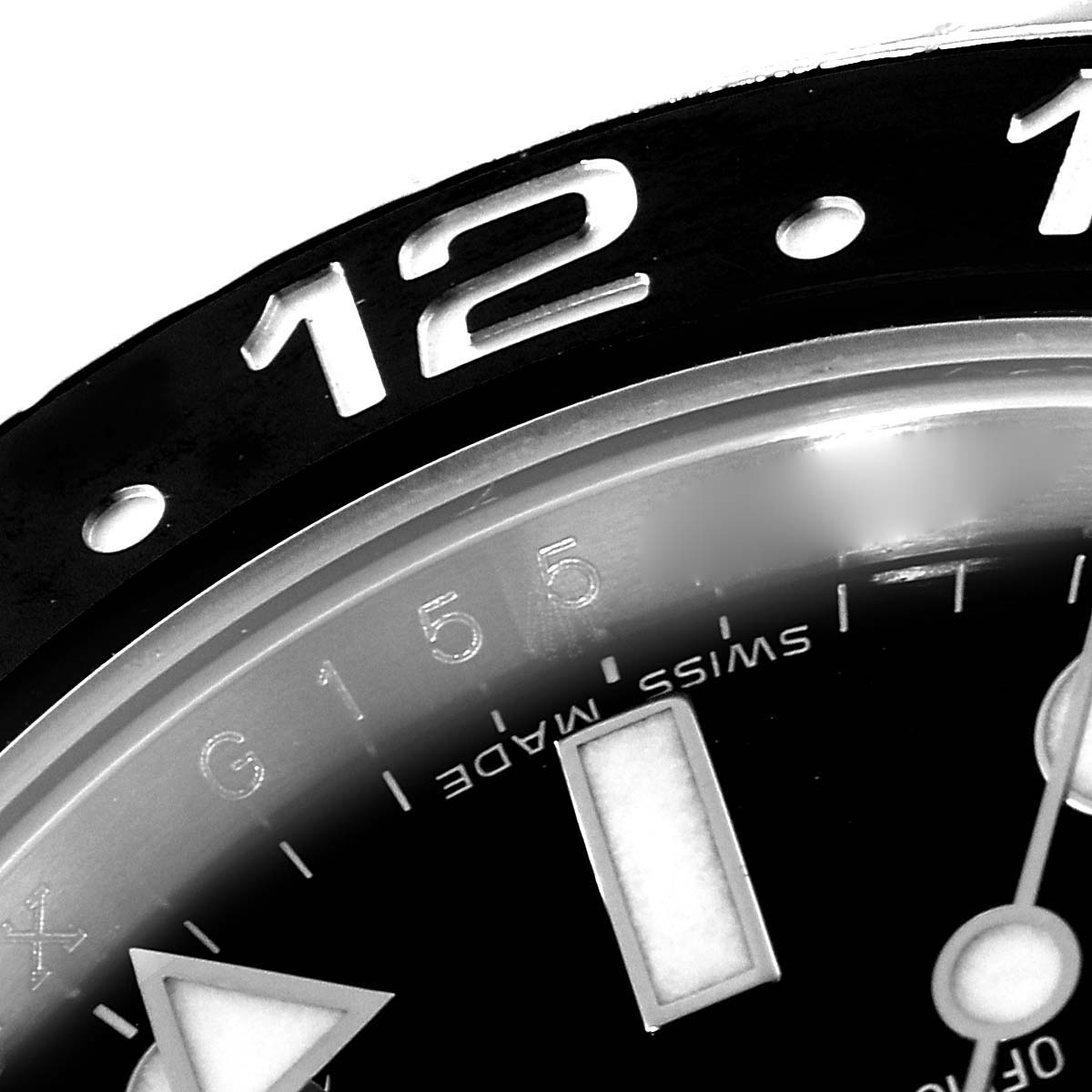 The image shows a close-up of the bezel and part of the dial of a Rolex GMT-Master 116710 Men's Stainless Steel Black Dial 116710 Men's Stainless Steel Black Dial watch, focusing on the 12 o'clock area.