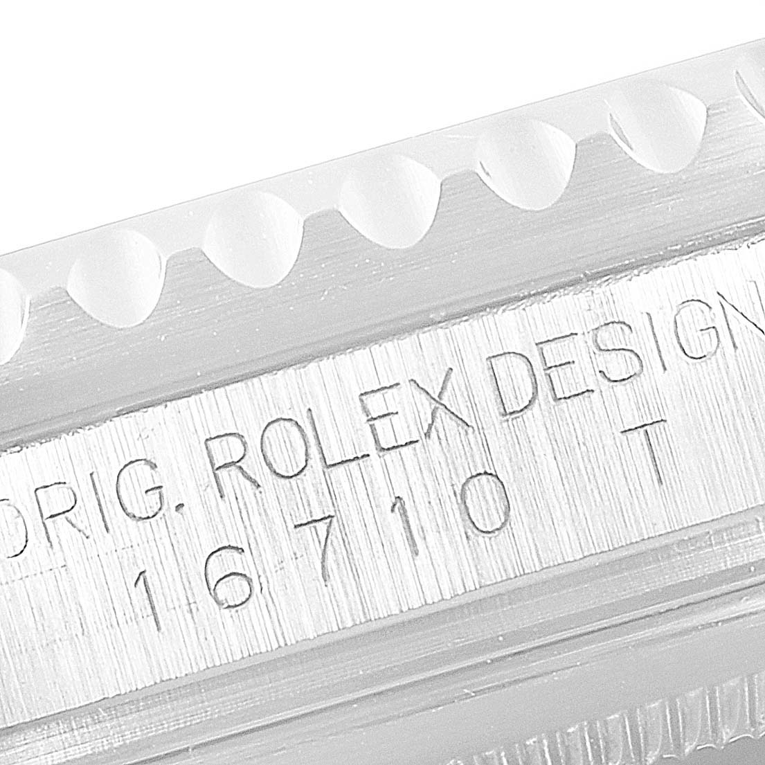 The image shows a close-up of the engraved side of a Rolex GMT-Master 16710 Men
s Stainless Steel Black Dial 16710 Men
s Stainless Steel Black Dial watch case, with the model number 16710.