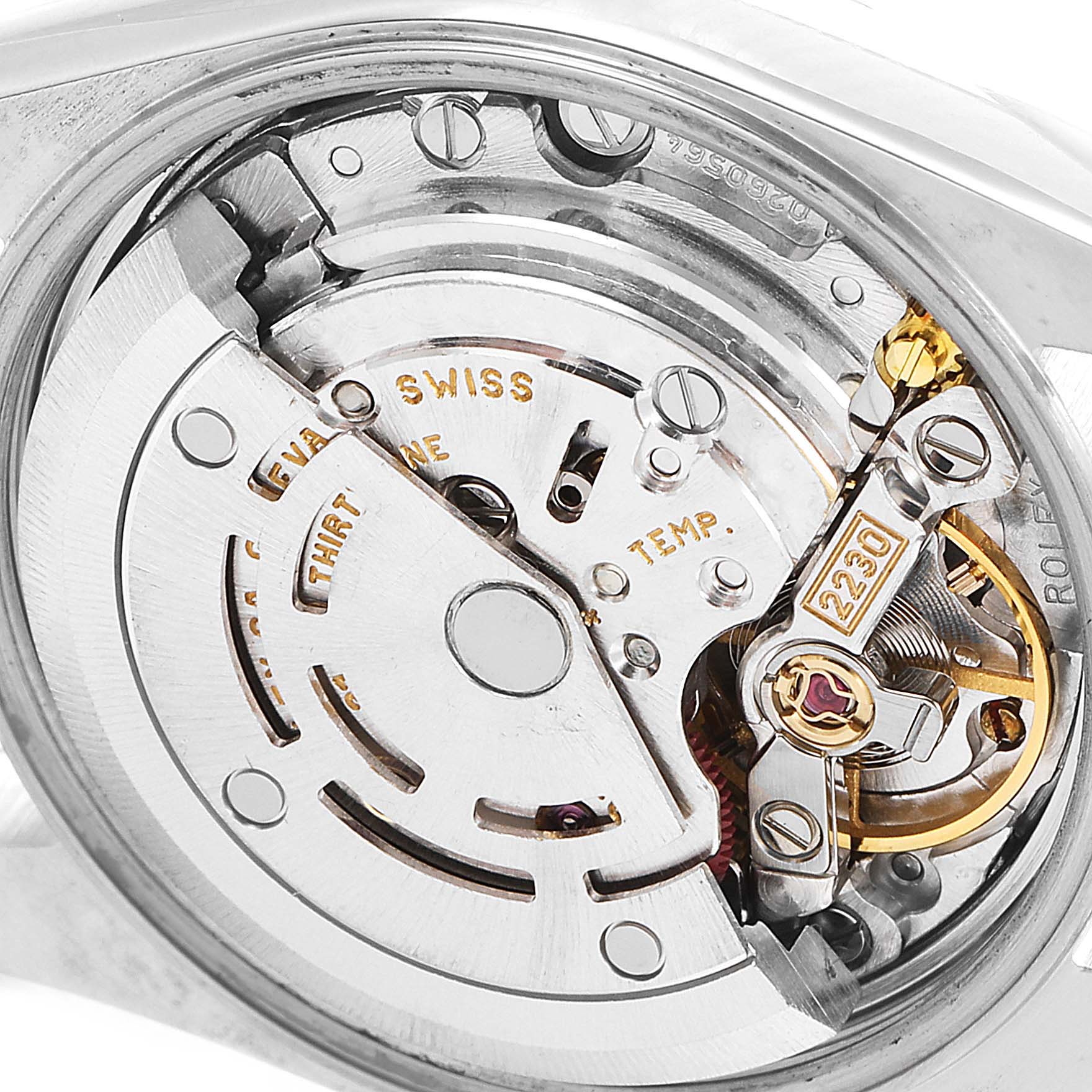 This image shows a close-up view of the internal mechanism of a Rolex Oyster Perpetual 76080 Women
s Stainless Steel Blue Dial 76080 Women
s Stainless Steel Blue Dial watch, highlighting the movement and intricate parts.