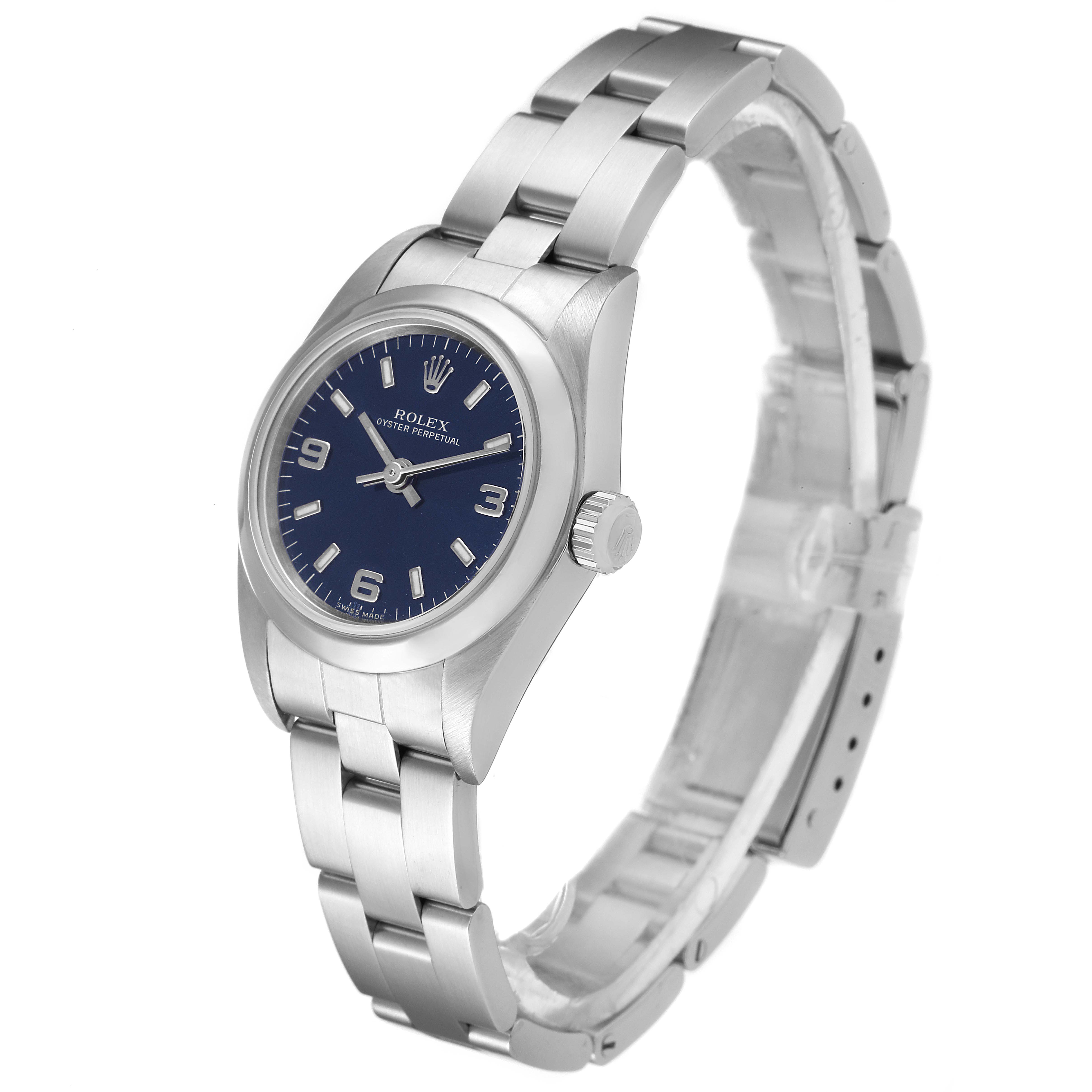 The image shows a side view of a Rolex Oyster Perpetual 76080 Women
s Stainless Steel Blue Dial 76080 Women
s Stainless Steel Blue Dial watch highlighting its blue dial, crown, and stainless steel bracelet.