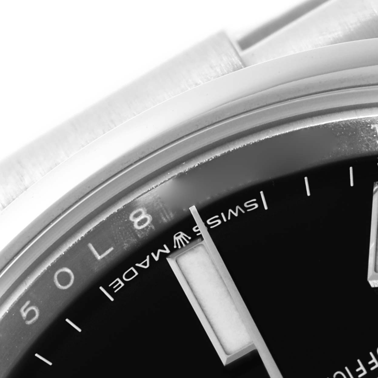 This image shows a close-up of the dial and edge of the bezel on a Rolex Oyster Perpetual 124200 Men's Stainless Steel Black Dial 124200 Men's Stainless Steel Black Dial watch.