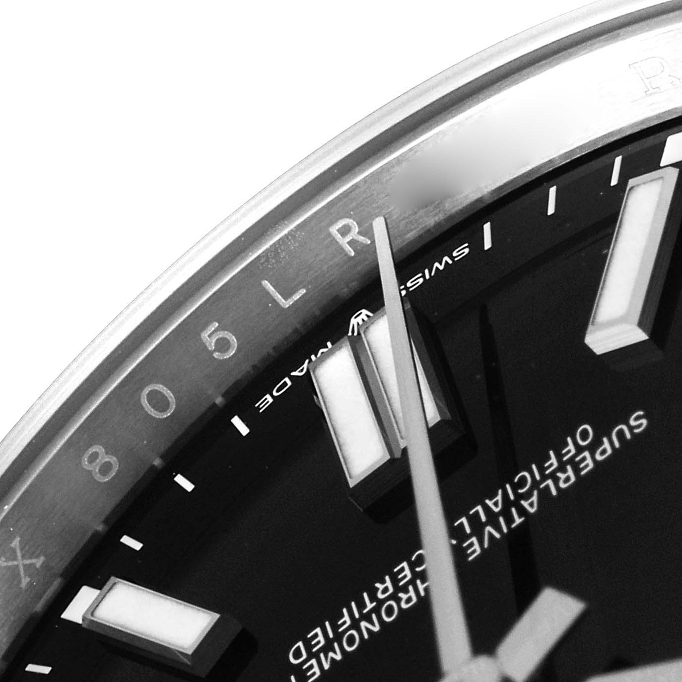 The image shows a close-up of the dial and hands of a Rolex Oyster Perpetual 124300 Men
s Stainless Steel Black Dial 124300 Men
s Stainless Steel Black Dial watch, highlighting indices and text.
