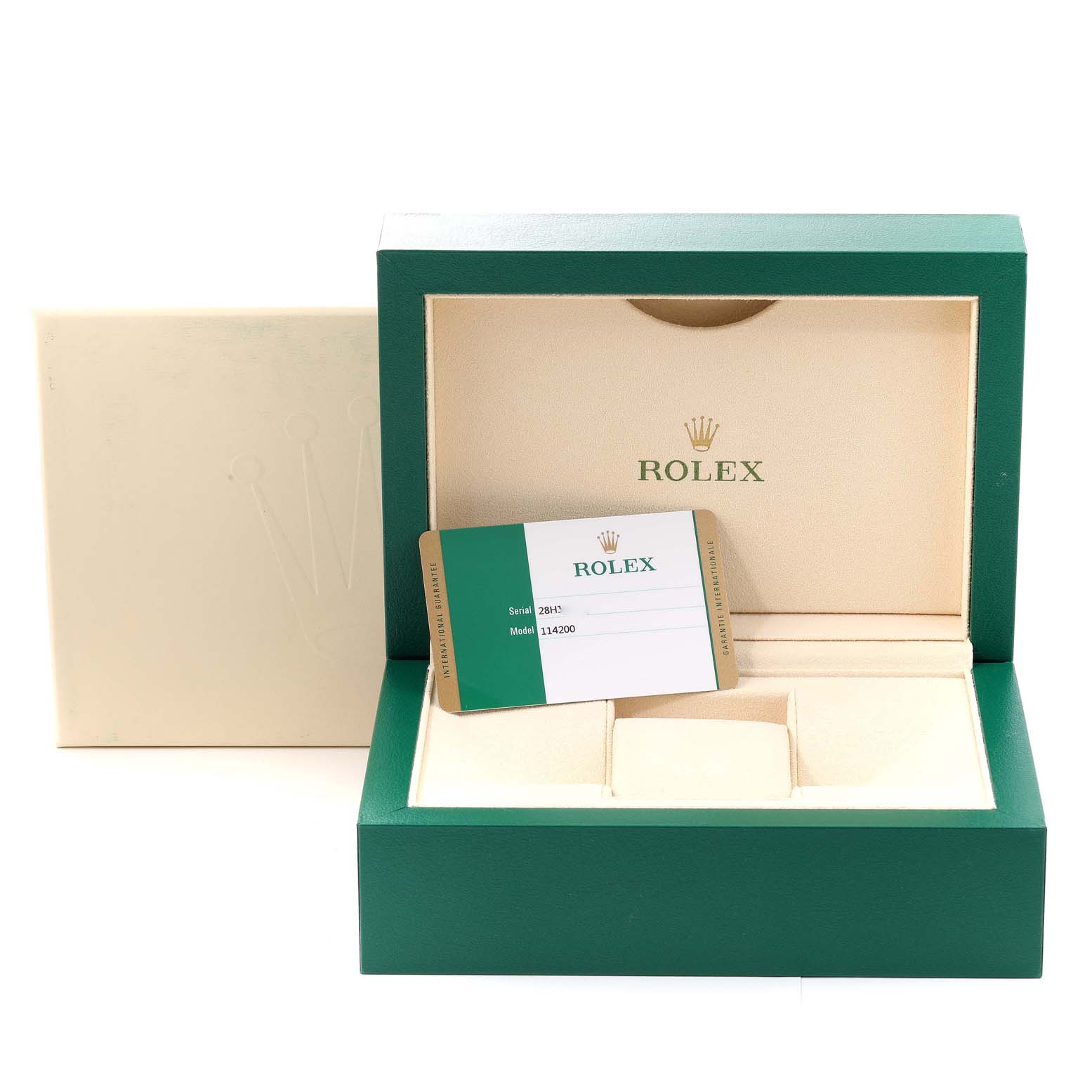 The image shows the open box and warranty card for a Rolex Oyster Perpetual 114200 Men
s Stainless Steel Green Dial 114200 Men
s Stainless Steel Green Dial model.
