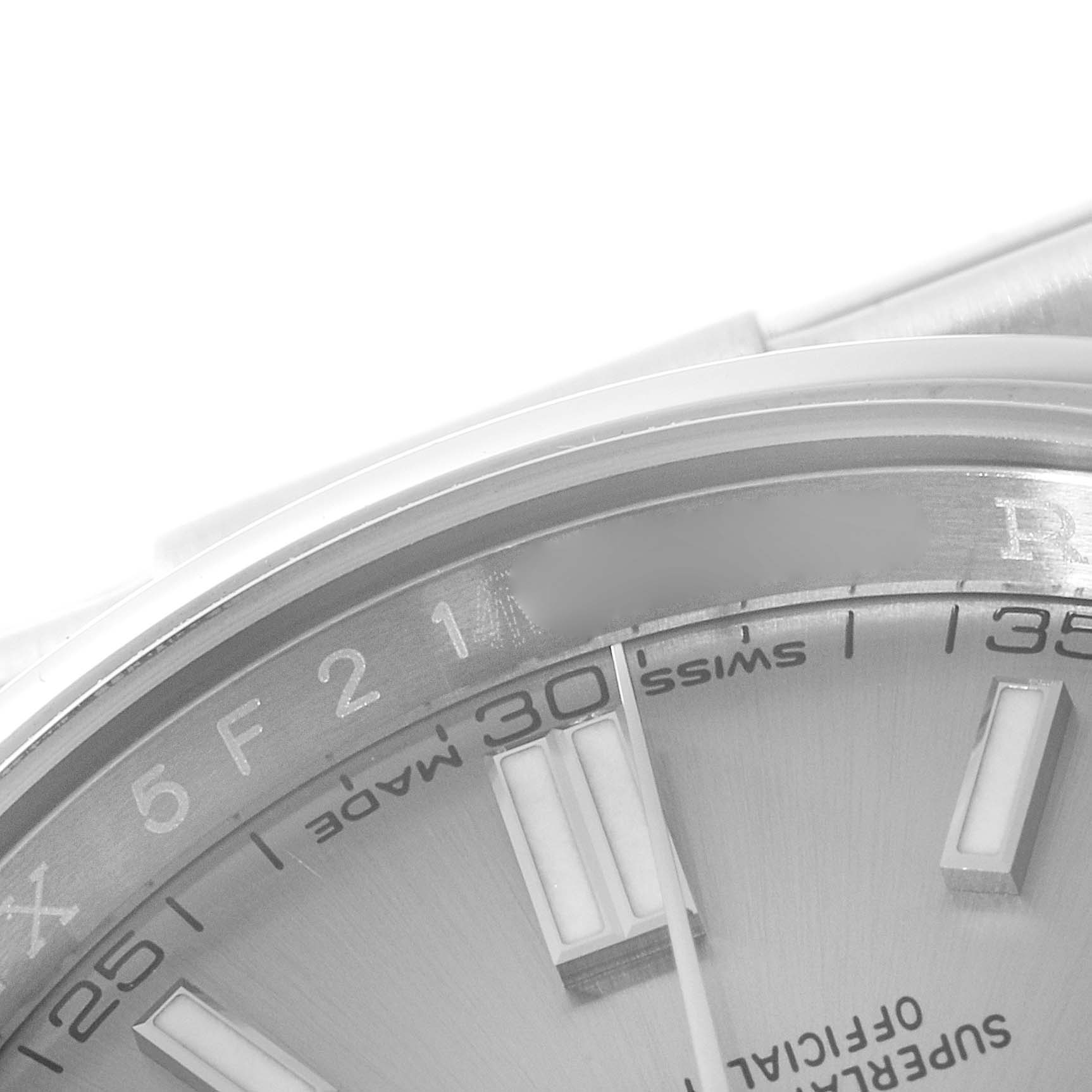 This image shows a close-up of the dial and part of the bezel of a Rolex Oyster Perpetual 116000 Men's Stainless Steel Grey Dial 116000 Men's Stainless Steel Grey Dial watch.