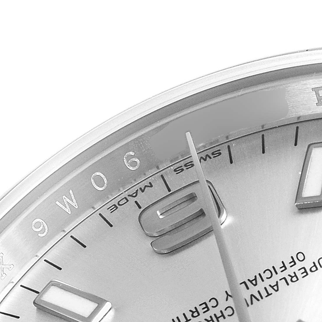 The image shows a close-up of the dial of a Rolex Oyster Perpetual 114200 Men's Stainless Steel Silver Dial 114200 Men's Stainless Steel Silver Dial watch, highlighting the "6" marker and second hand.