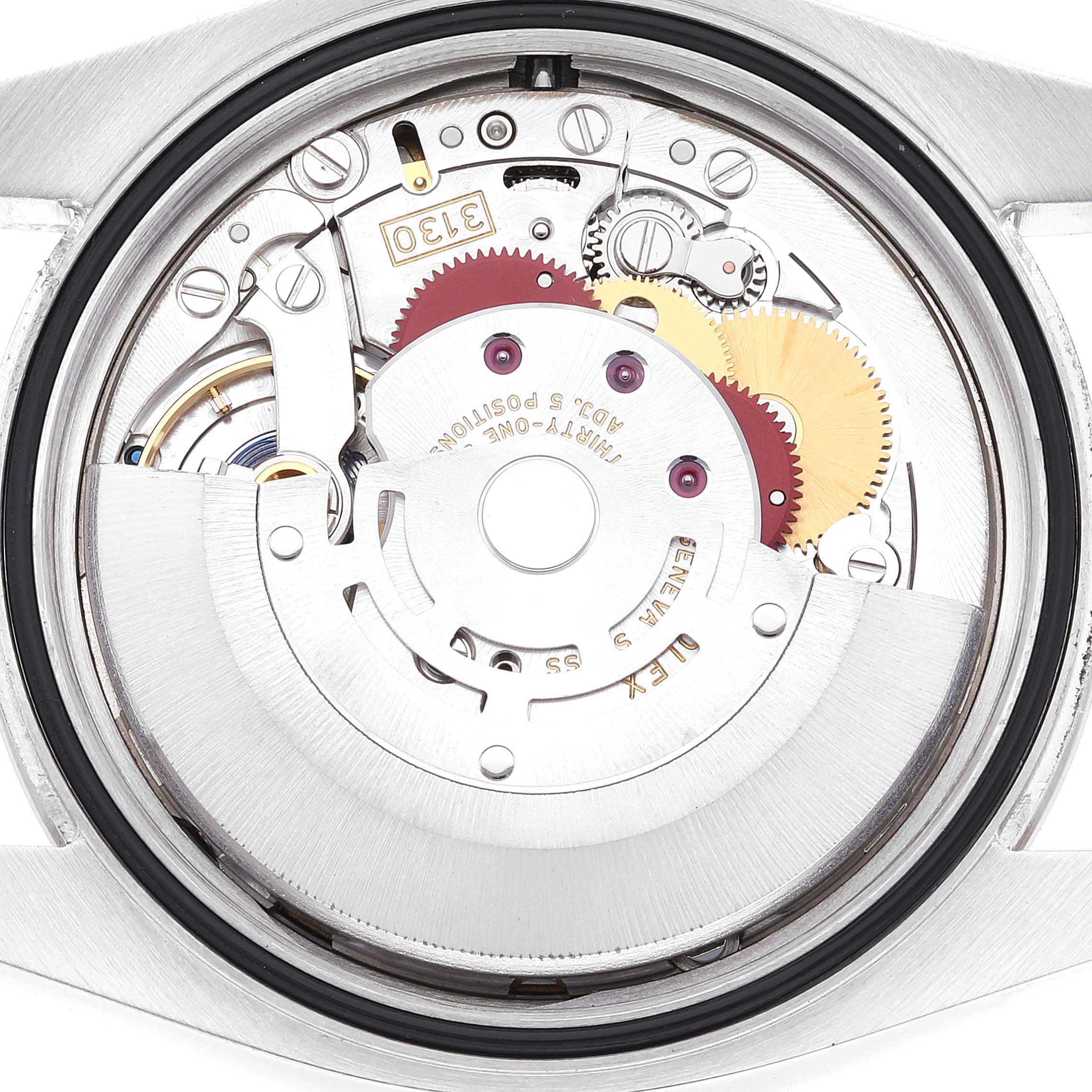 This image shows a close-up of the movement mechanism of a Rolex Oyster Perpetual 116034 Men's Stainless Steel Black Dial 116034 Men's Stainless Steel Black Dial watch.