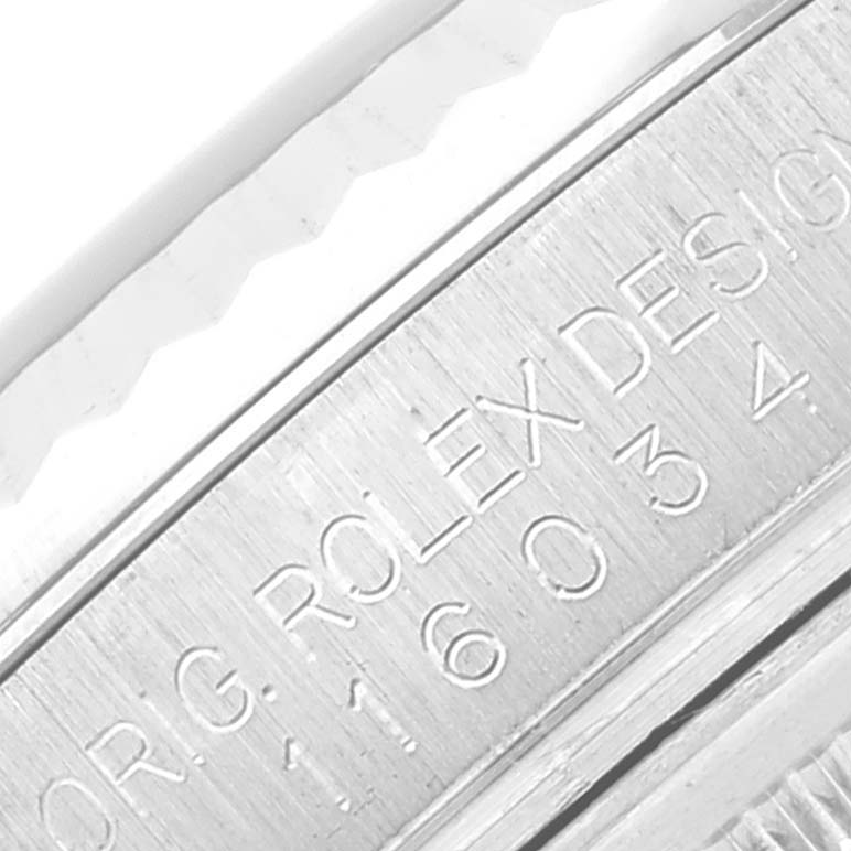 This image shows a close-up of the side engraving on the case of a Rolex Oyster Perpetual 116034 Men
s Stainless Steel Black Dial 116034 Men
s Stainless Steel Black Dial watch.