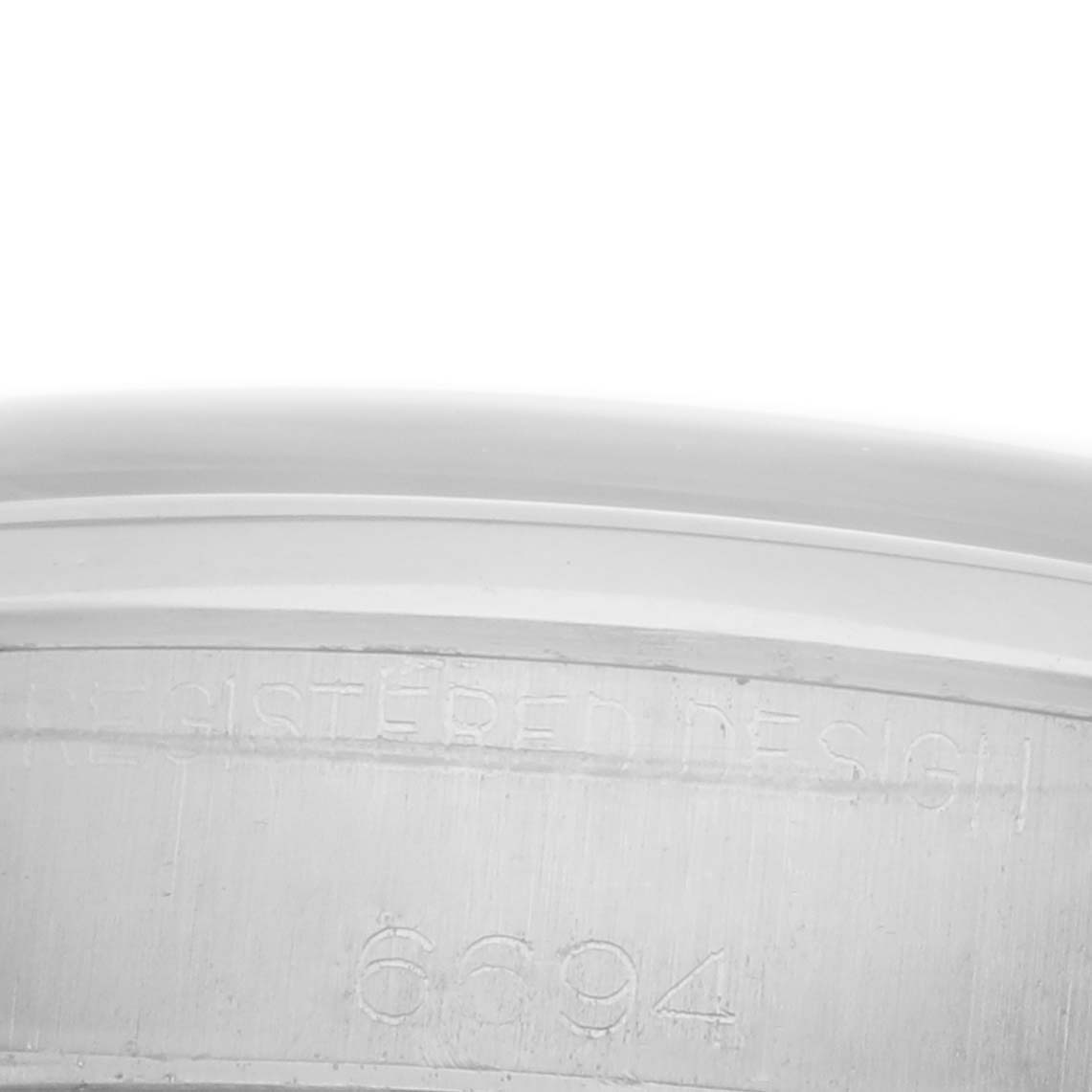 The image shows a close-up of the Rolex Vintage Collection 6694 Men
s Stainless Steel Silver Dial model
s inner case, highlighting the engraved design numbers.