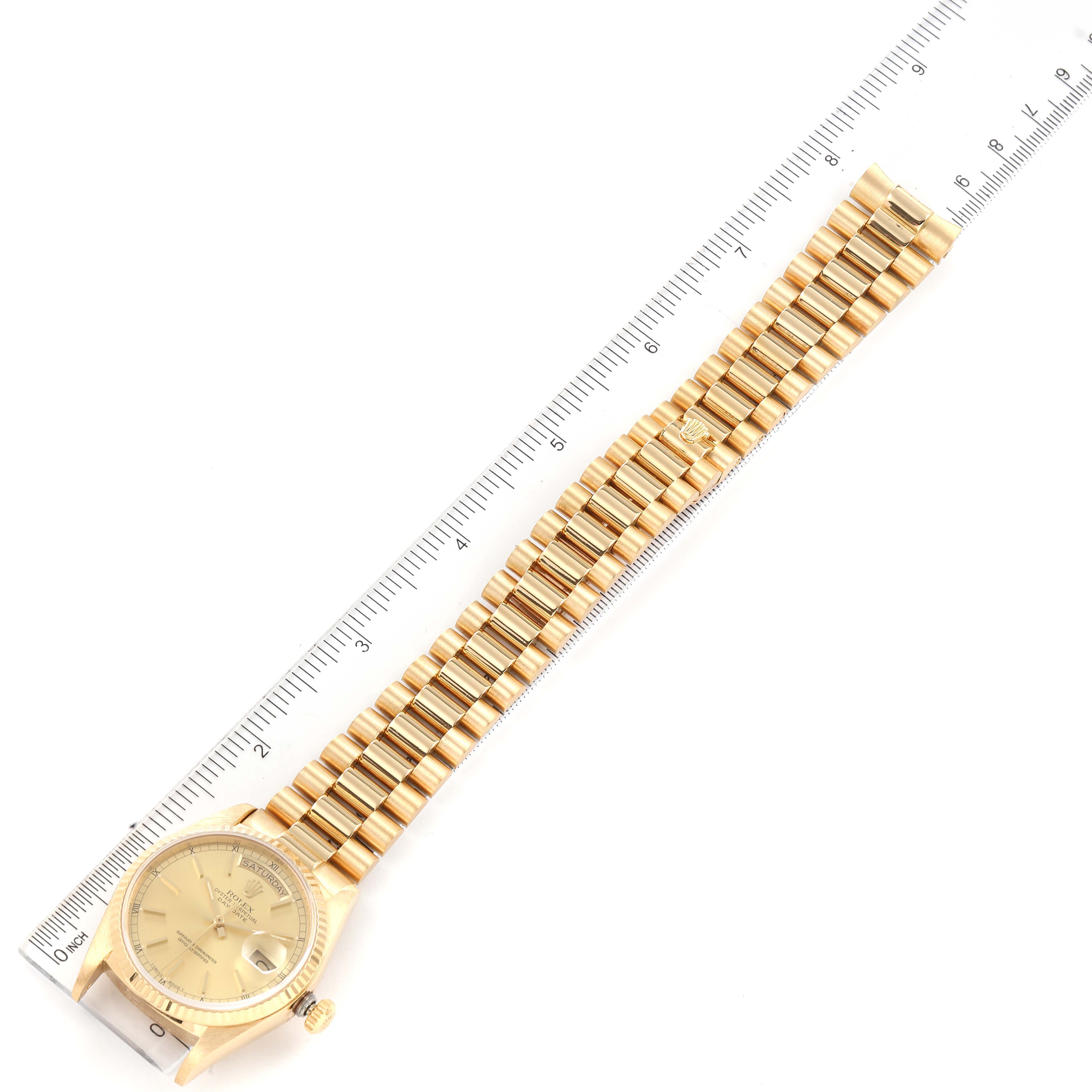 This Rolex President 18038 Men's Yellow Gold Champagne Dial 18038 Men's Yellow Gold Champagne Dial model watch is shown laid flat with a ruler, displaying the face, case, and full bracelet.